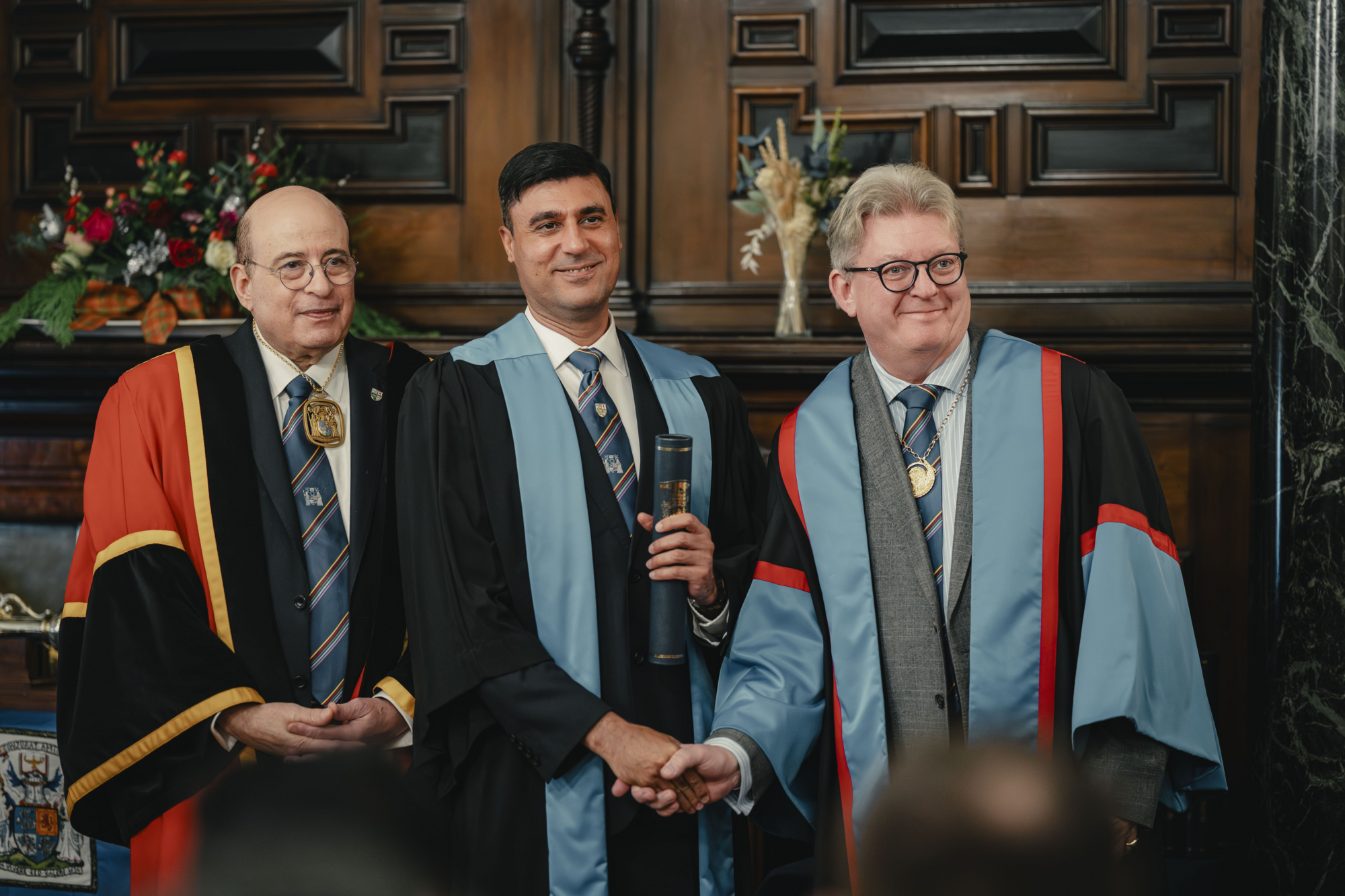 A diplomat receiving their diploma